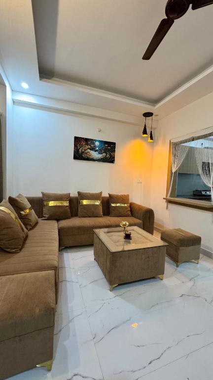 a living room with a couch and a coffee table at Healer home in Rishīkesh