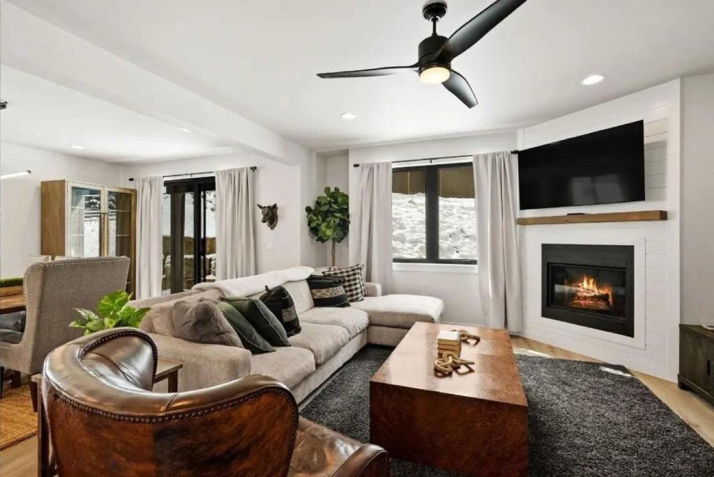 a living room with a couch and a fireplace at Cozy Luxury in Big Sky in Big Sky
