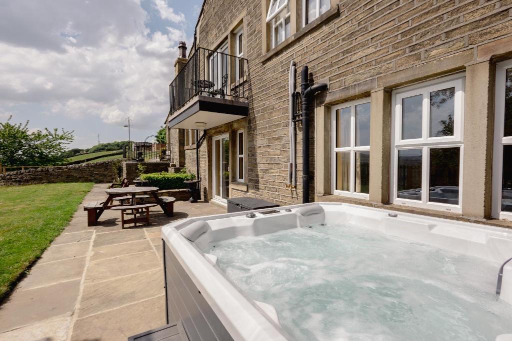 a hot tub in the backyard of a house at Great Edge in Luddenden Foot