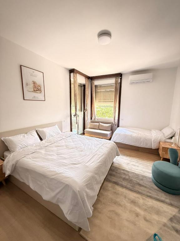 a bedroom with two beds and a window at Happy Hue rooms Malpensa airport in Samarate