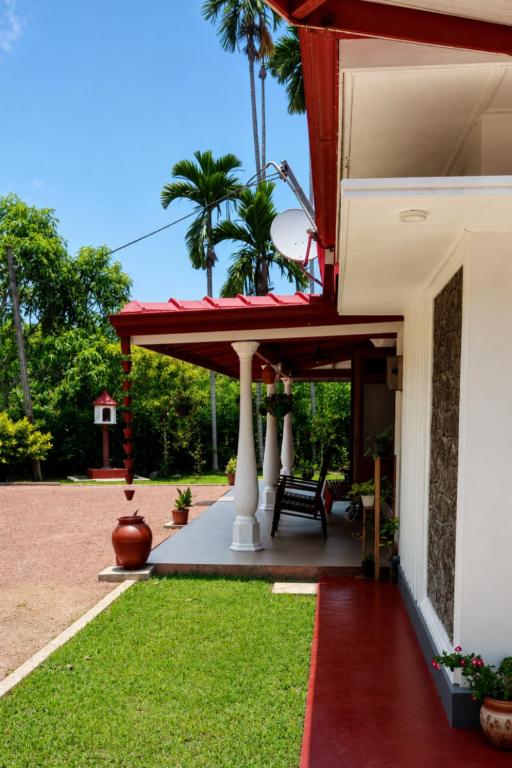 a porch of a house with a red roof at Villa Serene Herbs Dickwella in Dickwella