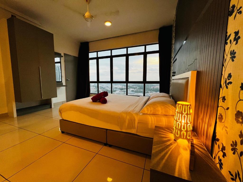 a bedroom with a bed with a red teddy bear on it at Comfort Zone Premium Guesthouse @ Evo Bangi in Bangi