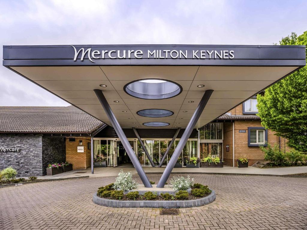 a building with a sign in front of it at Mercure Milton Keynes Hotel in Milton Keynes