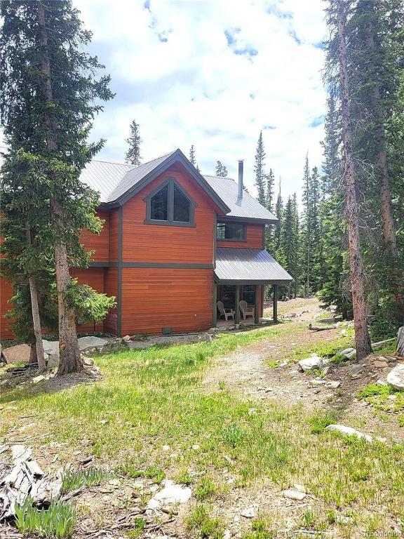 a wooden cabin in the middle of a forest at Mountain Modern 4 Bedroom Cabin on Hiking Trails in Fairplay