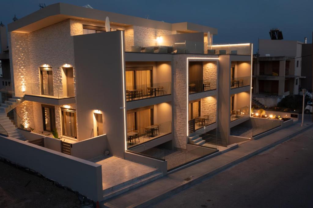 a large building with lights on it at night at Santerra Suites in Rhodes Town