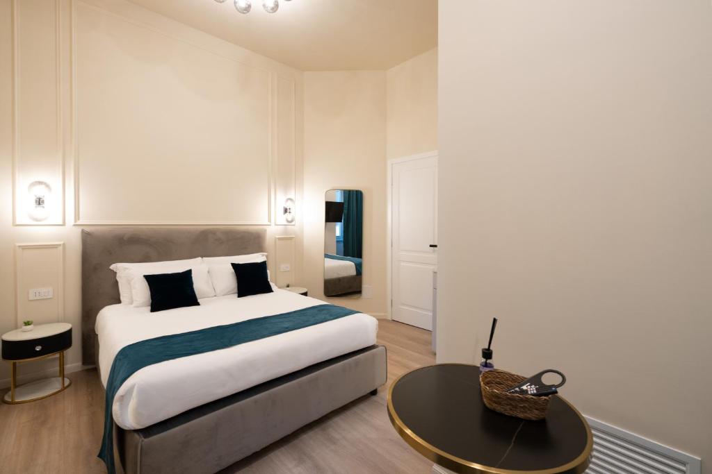 a bedroom with a large bed and a table at Aethel Guesthouse in Rome