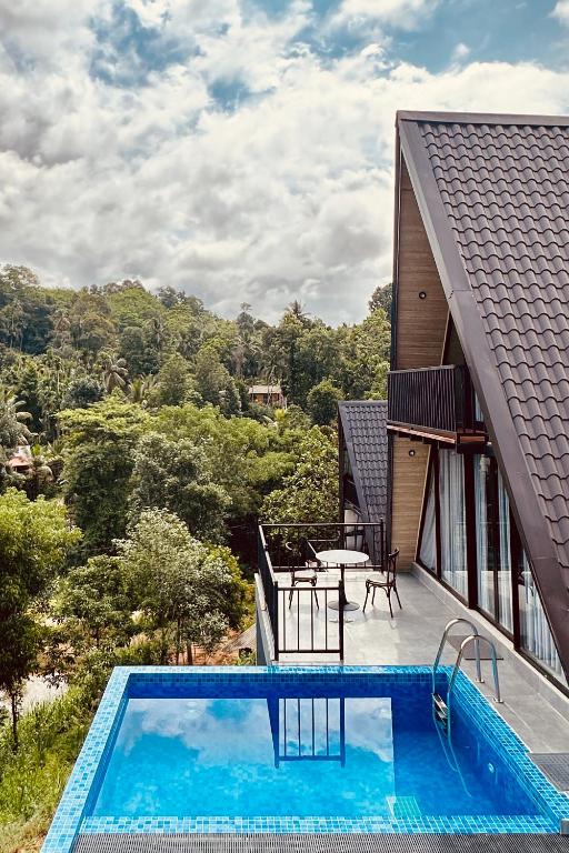 a view of a house with a swimming pool at Bherunda Mount Resort in Kegalle