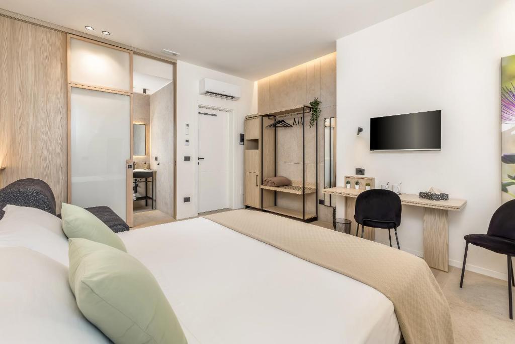 a hotel room with a bed and a tv at Grafea - Luxury stay in Catania in Catania