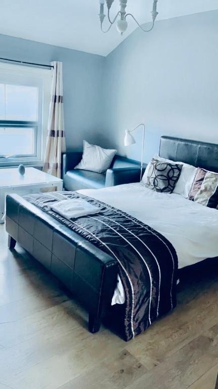 a bedroom with a large bed and a couch at Bedford Station Rest Stop in Bedford