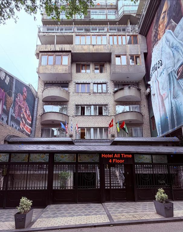 a building with aoked all time sign in front of it at Hotel All Time in Tbilisi City