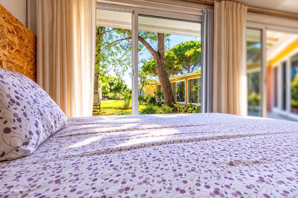 a bedroom with a purple bed with a large window at Jacaranda in Cádiz