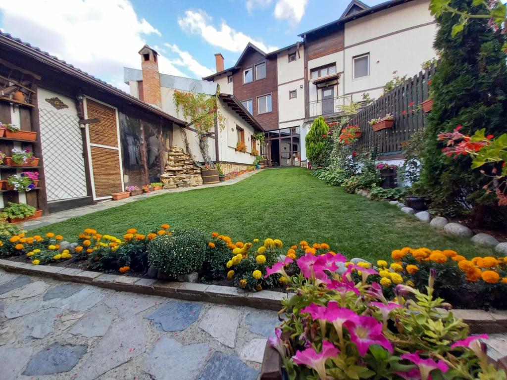 a garden with flowers in the middle of a street at Deny Holiday home in Dobrinishte