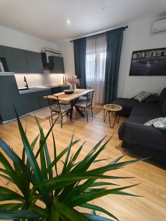 a living room with a couch and a table at Olive Tree Apartment in Kaštela