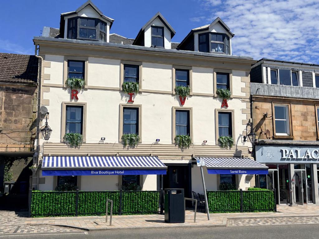 a large white building with windows on a street at Riva Boutique Hotel in Helensburgh