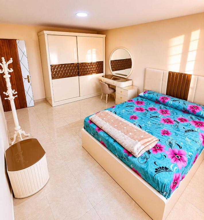 a bedroom with a large bed and a desk at Tiba Golden beach resort hurghada down town in Hurghada