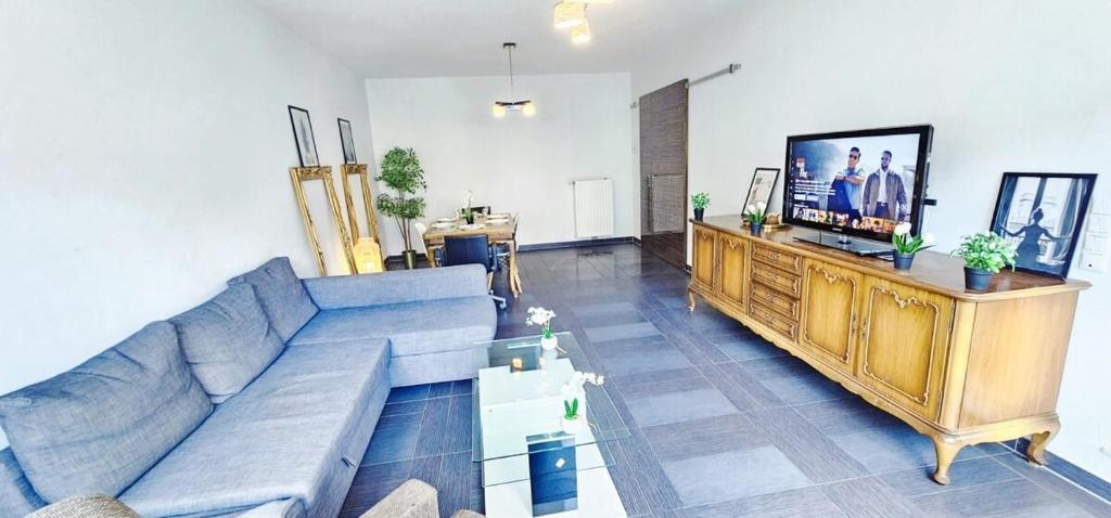 a living room with a couch and a flat screen tv at Central Luxembourg Stay-2BR in Hollerich