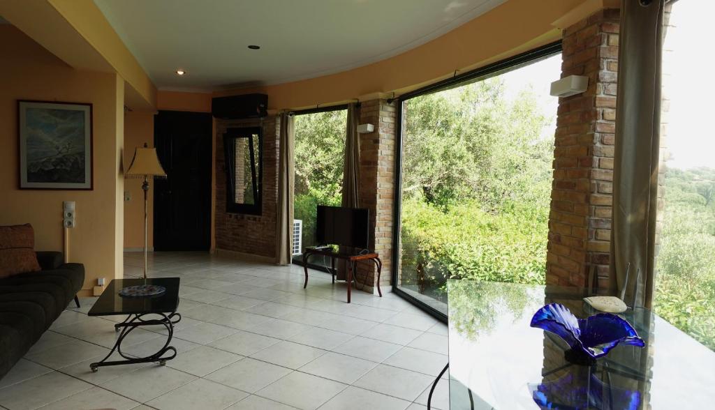 a living room with a couch and a large window at One Bedroom Villa in Alikanas