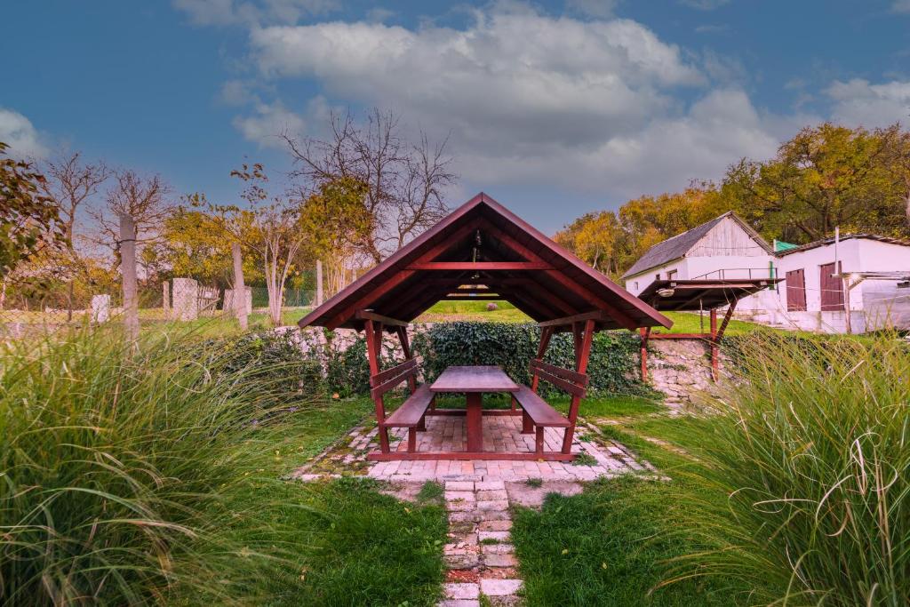 a gazebo in a field of grass with at Hege Vendégház in Bükkmogyorósd