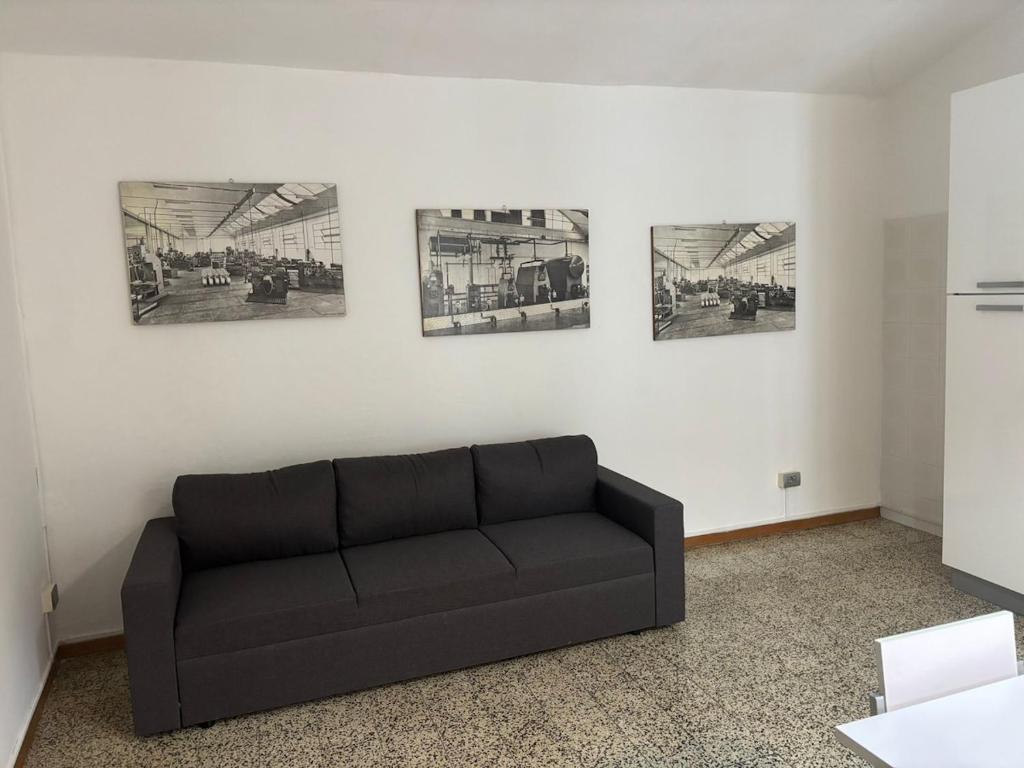 a black couch in a room with pictures on the wall at Casa Limmy in Intra