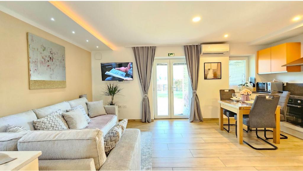 a living room with a couch and a kitchen at Istrian Lux Residence by Istrian apartments Koper in Koper