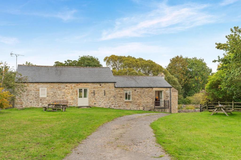 a stone house with a gravel road in front of it at 3 Bed in Bishop Auckland oc-36671 in Wolsingham