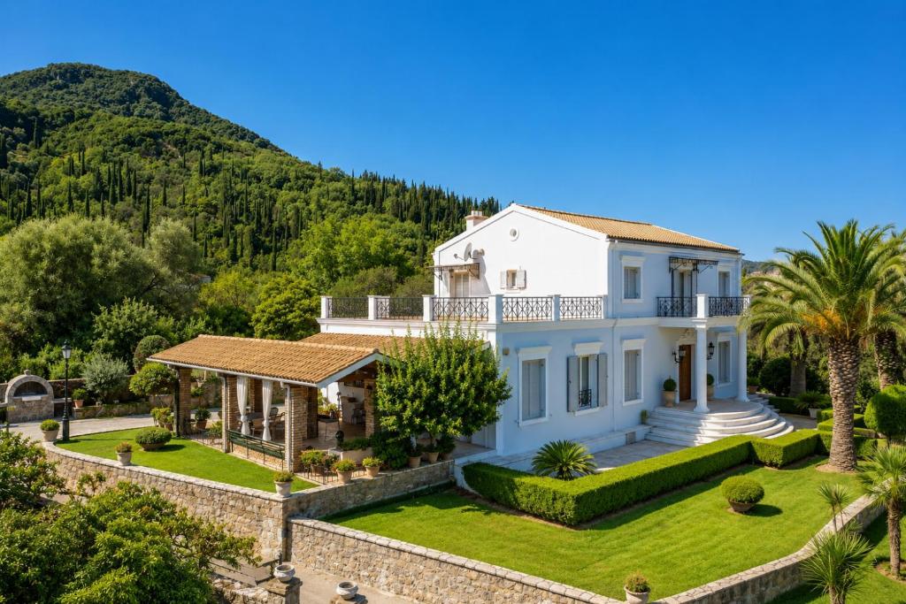 an aerial view of a white house with palm trees at Villa Golden Tiara Large Private Pool AC WiFi in Corfu