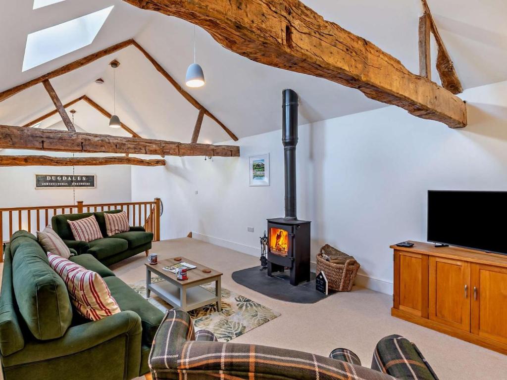 a living room with a couch and a wood stove at 2 Bed in Settle oc-g0051 in Settle