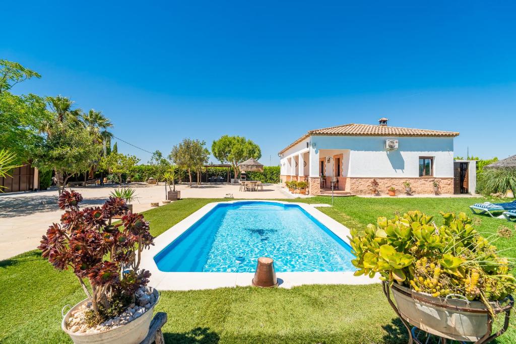 a house with a swimming pool in a yard at Casa Rural Villa Lucrecia in La Lantejuela