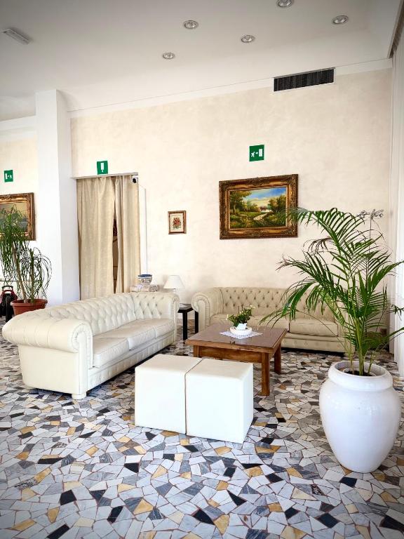 a living room with a couch and a table at Hotel Cristallo - Chianciano Terme in Chianciano Terme