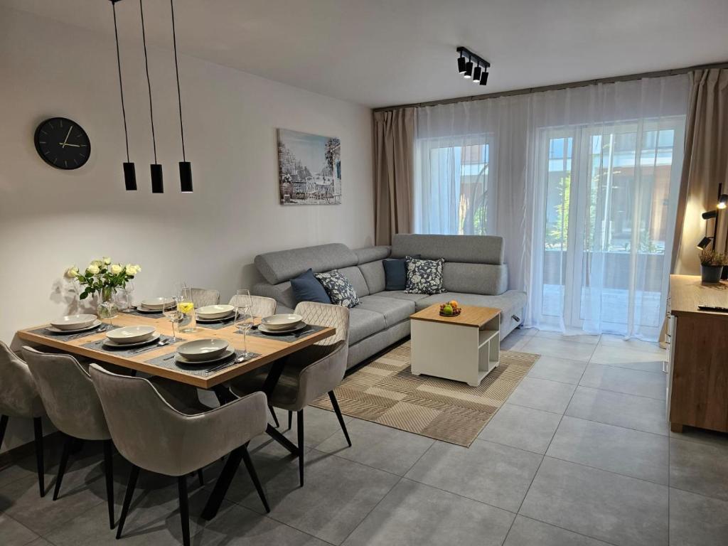 a living room with a table and a couch at Blue Wave Pobierowo in Pobierowo