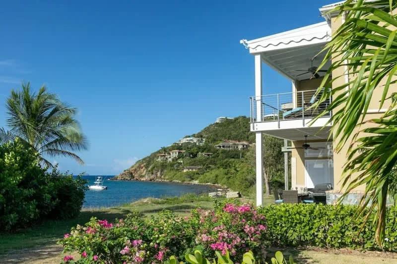 a house with a view of the ocean at Mahalo Villa Beachfront Generator in Cruz Bay