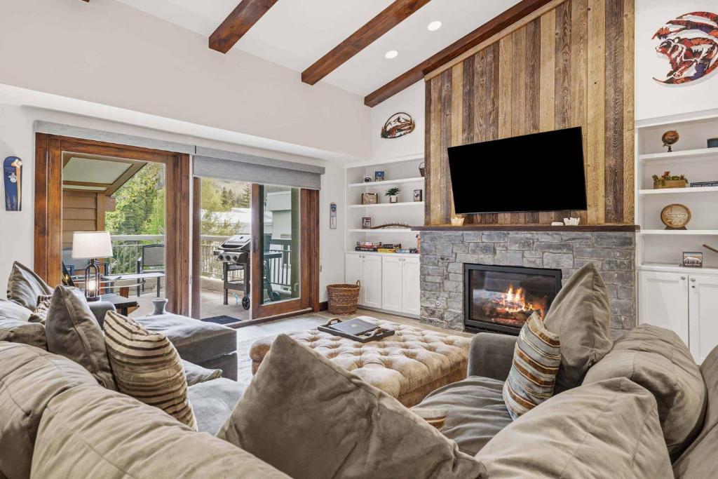 a living room with a couch and a fireplace at Lodge at Lionshead 403 in Vail