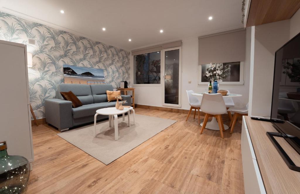 a living room with a couch and a table at La Concha Pearl Beach Apartment in San Sebastián