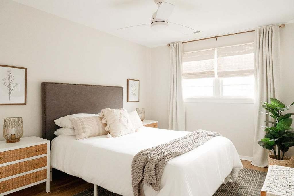 a white bedroom with a large bed and a window at Airy 3BD Cottage Yard Grill & Steps to Beach in Folly Beach