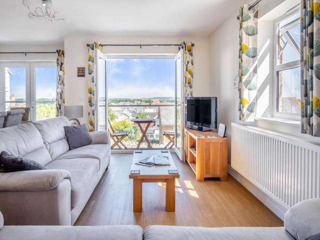 a living room with a couch and a tv at 3 Bed in Shanklin oc-ic180 in Shanklin