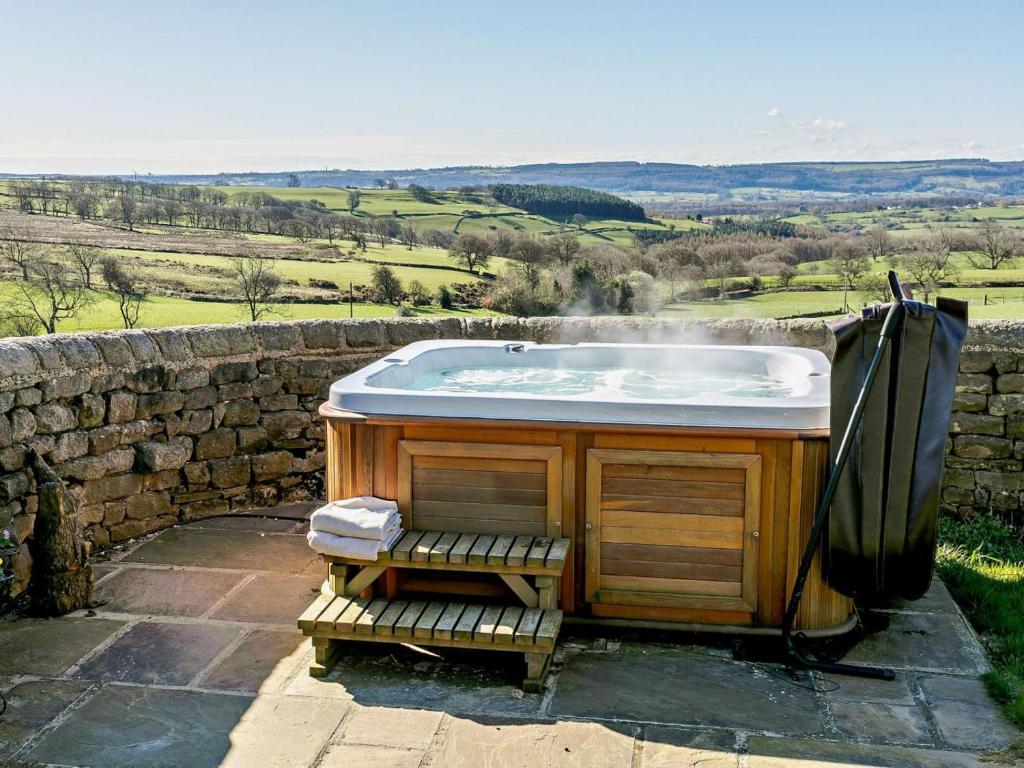a bath tub sitting on top of a stone wall at 2 Bed in Harrogate oc-hh018 in Lindley