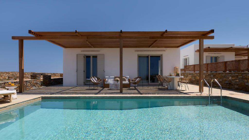 a villa with a swimming pool and a house at Didimos Luxury Villas in Cherronisos