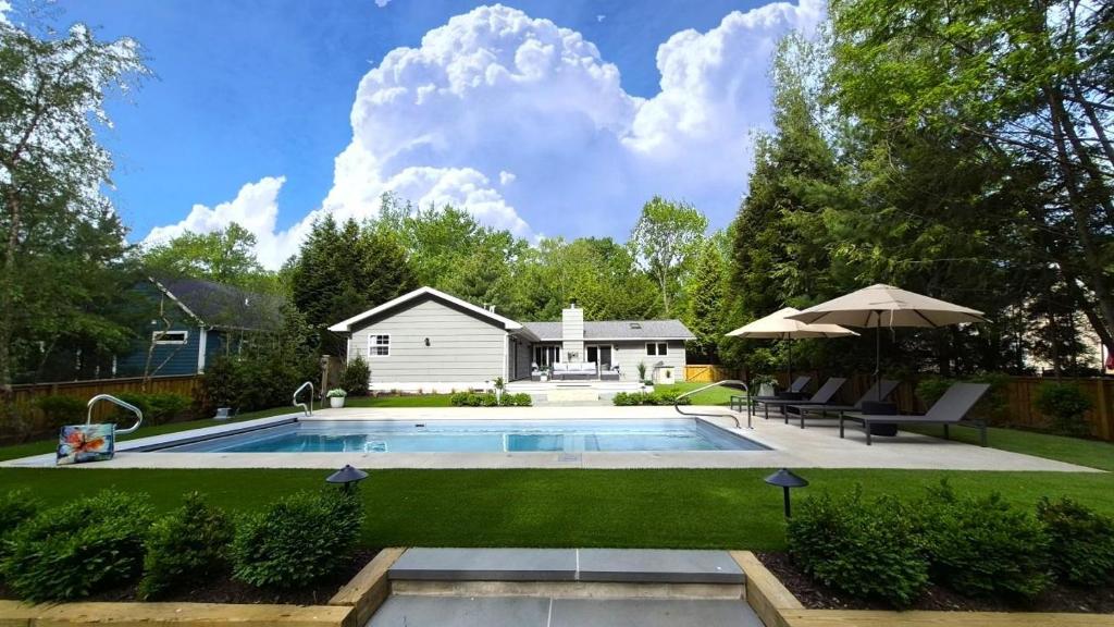 a backyard with a swimming pool and a house at Hidden Haven in Union Pier