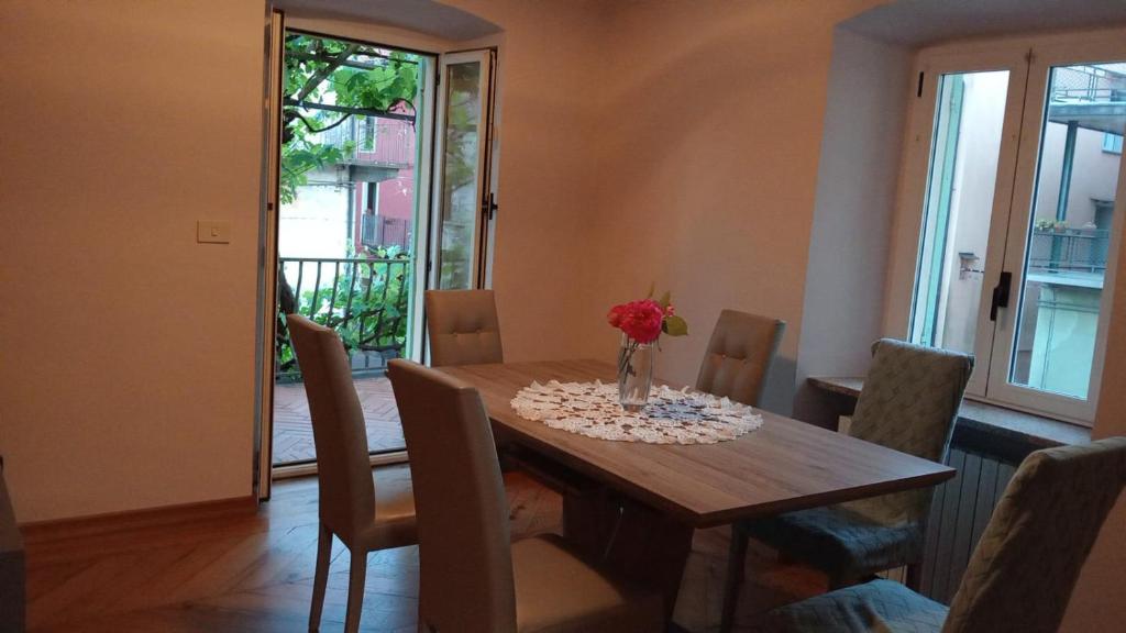 a dining room table with a vase of flowers on it at La pergola in Sagliano Micca