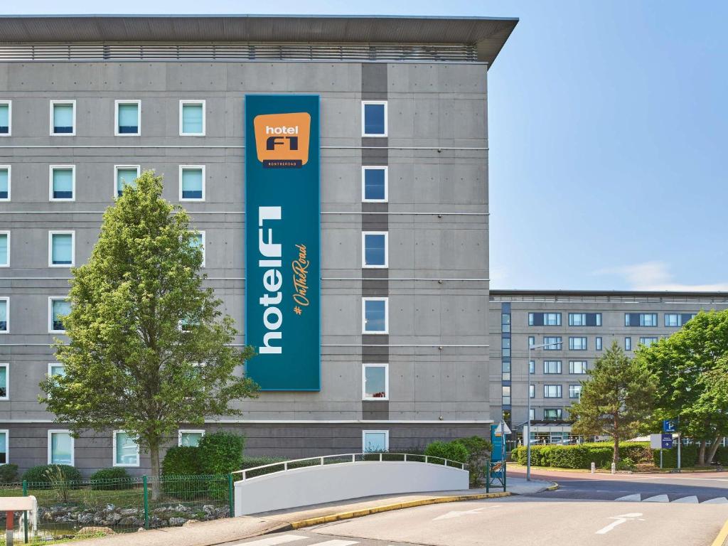 a building with a sign on the side of it at hotelF1 Roissy CDG Pn2 in Roissy-en-France