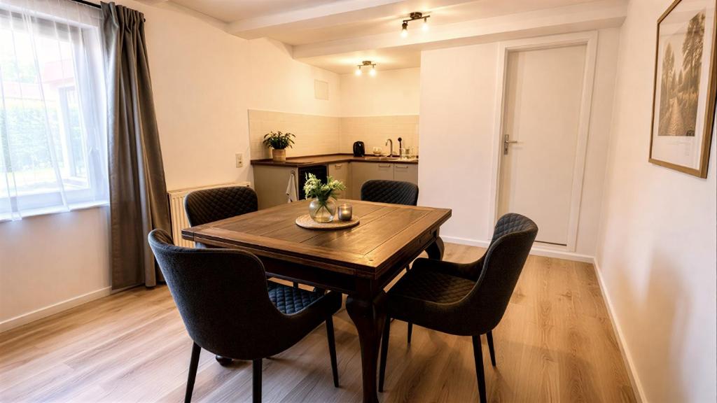 a dining room with a wooden table and chairs at Ferienwohnung Hoffmann in Radebeul