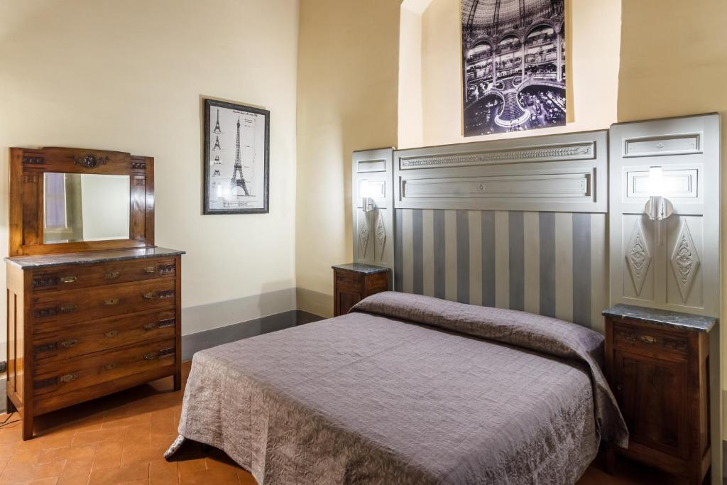 Postel nebo postele na pokoji v ubytování Dimora Storica Palazzo Puccini