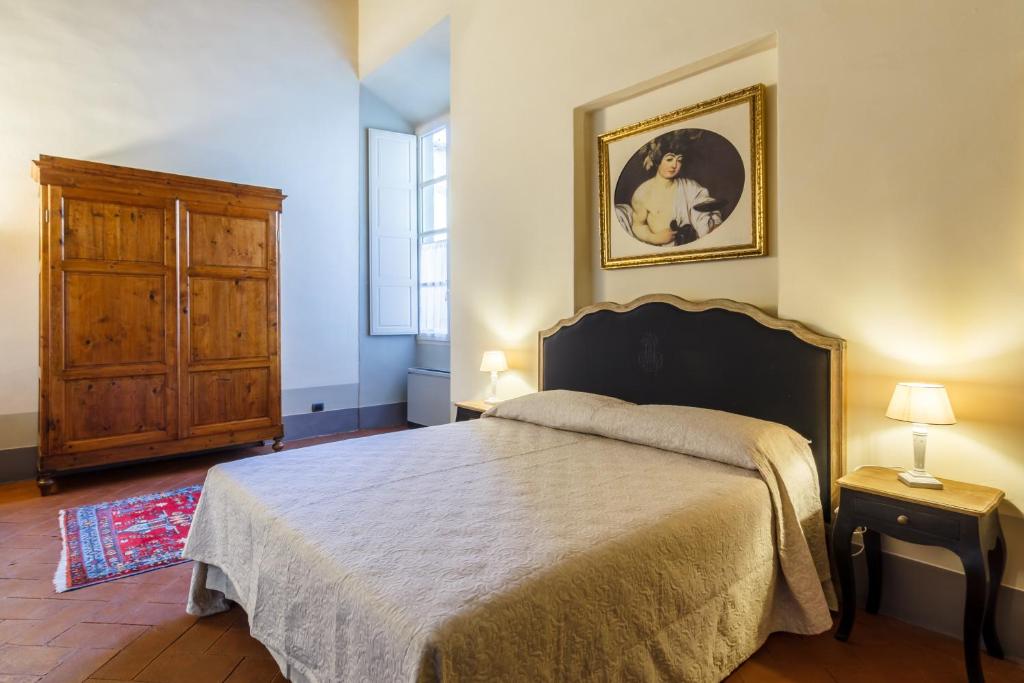 Postel nebo postele na pokoji v ubytování Dimora Storica Palazzo Puccini