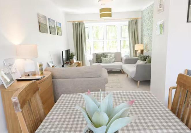 a living room with a table with a plant on it at Willow View Streamside Retreat near Kynren Durham in Newton Aycliffe