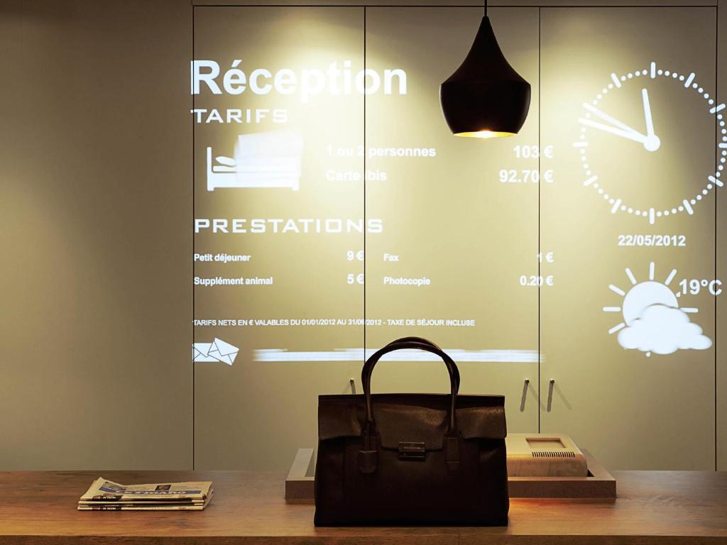 a bag sitting on a table in front of a window at Ibis Bacabal in Bacabal