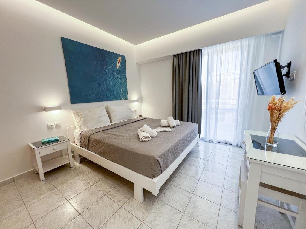 a hotel room with a bed and a table at Casa al' Tati Apartments in Ialysos