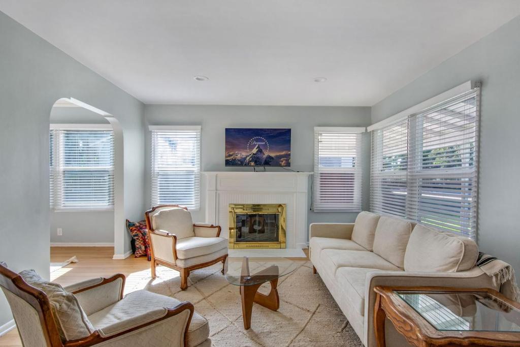 a living room with a couch and a fireplace at Welcome To Riverside - Spacious, Cozy, Central in Riverside
