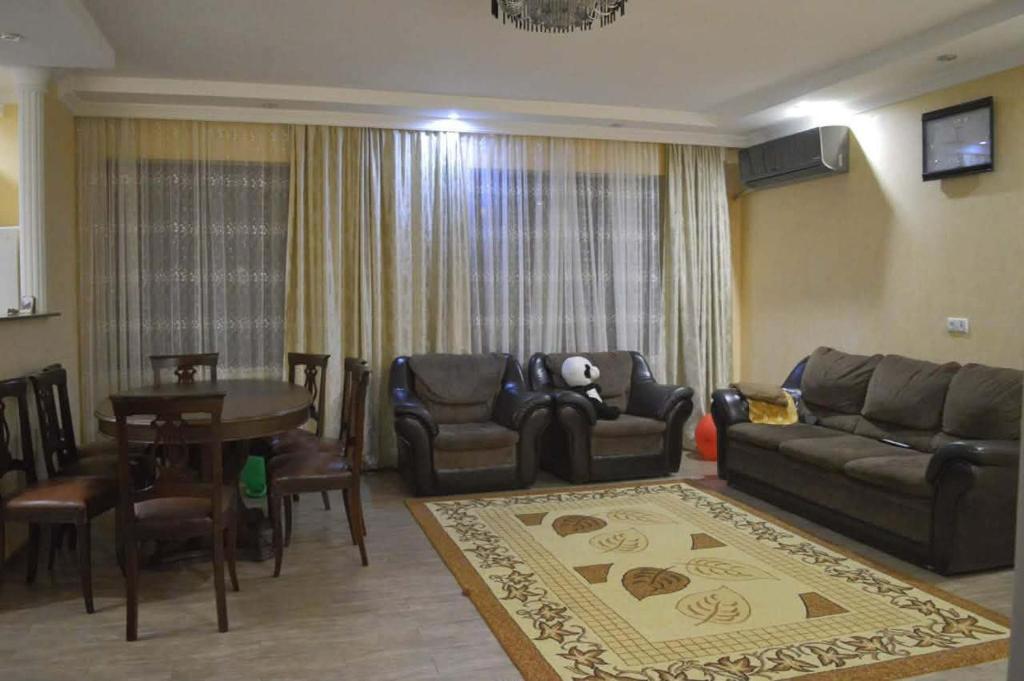 a living room with a couch and a table at Apartament 2 in Gonio