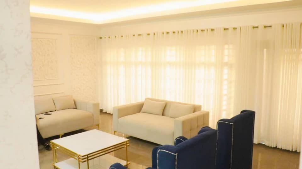 a living room with a couch and a table at MAI instahomes in Lilongwe