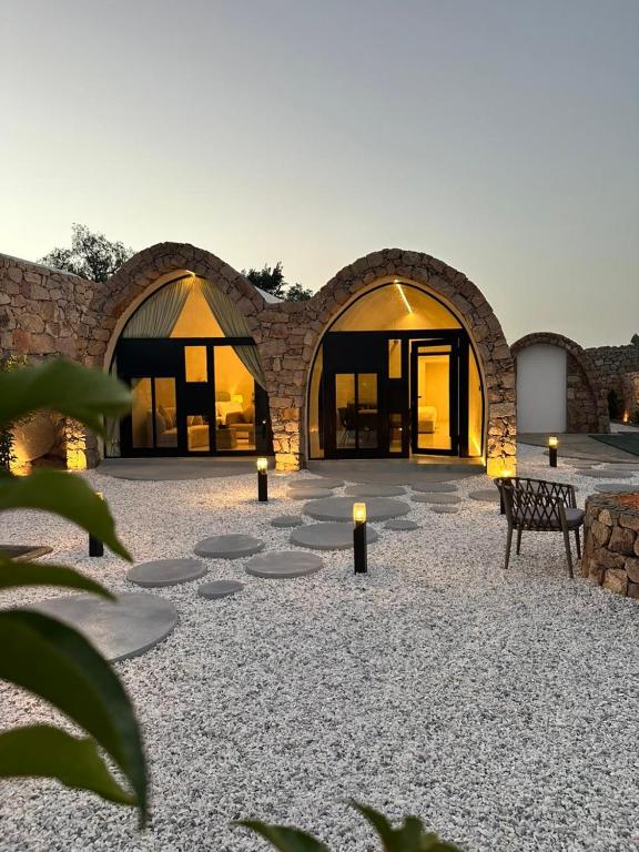 a stone building with lights in a courtyard at في كامب الهدا v camp in Taif